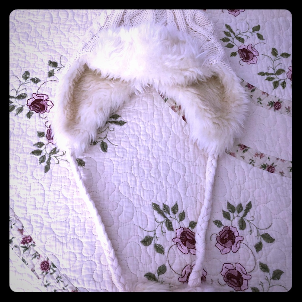 Cable beanie with braided cords and pom poms